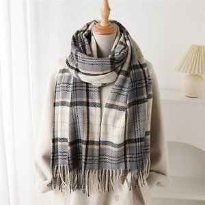 Classic gray and beige plaid cashmere-like scarf with long tassels on a mannequin