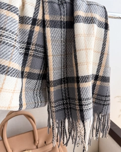 Close-up of classic checkered scarf with soft fringe and premium faux cashmere texture