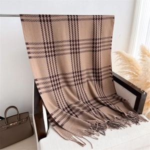 Close-up of brown checkered scarf texture with fringe detail on a white chair