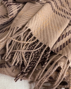 Detailed view of camel herringbone scarf with subtle gold lurex and soft long fringe