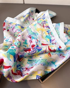 Dettaglio di un foulard di seta a fiori colorati con finitura satinata su vassoio