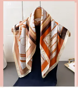 Close-up of equestrian print silk scarf featuring horse bits and chain patterns