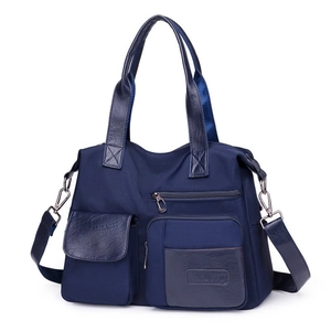 Navy blue nylon tote bag with multiple functional pockets and adjustable shoulder strap