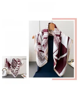 Close-up of vintage floral and geometric print silk scarf with burgundy and cream contrast