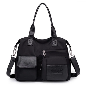 Classic black nylon and leather tote bag with adjustable shoulder strap for daily commute