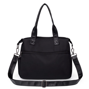 Minimalist black nylon tote bag with leather handles and multiple zipper pockets for daily use