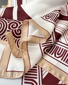 Close-up detail of vintage printed silk scarf showing twill texture and geometric patterns