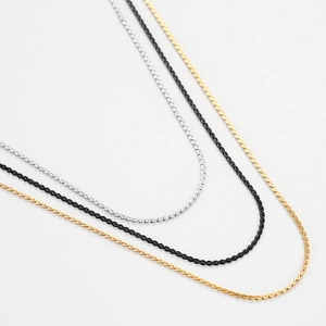 Three sleek titanium steel S-chains in silver, gold, and black colors for women