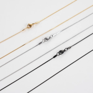 Detail of titanium steel wave chains in gold, silver, and black finishes with lobster clasps