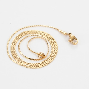 Detailed view of golden twisted wave chain necklace featuring a secure lobster clasp closure