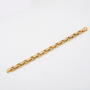 Detailed macro view of gold plated curb chain bracelet with micro-paved white zircons
