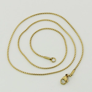 Close-up of golden stainless steel S-chain necklace with a lobster clasp closure
