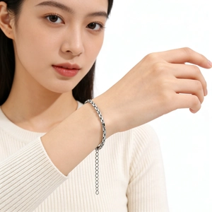 Close-up of polished silver steel chain bracelet with adjustable extender on wrist