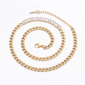 Detail of 18K gold stainless steel Cuban chain necklace with baguette cubic zirconia