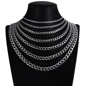 Set of silver stainless steel Cuban link chains in various sizes on a black mannequin