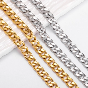 Detailed view of polished gold and silver Cuban link chains in flat stainless steel
