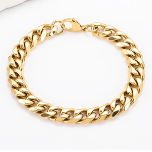 Close-up of polished gold Cuban link bracelet with a secure lobster clasp closure