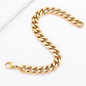 Mens hip hop golden stainless steel Cuban link bracelet with lobster clasp on white surface