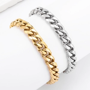 Detail of hip hop Cuban link bracelets in polished gold and silver stainless steel