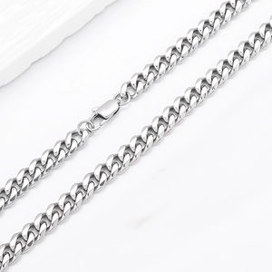 Detailed macro view of the silver stainless steel curb chain with a secure lobster clasp