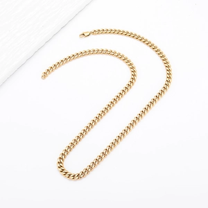 Detailed view of a golden Cuban link chain with a secure lobster clasp on white background