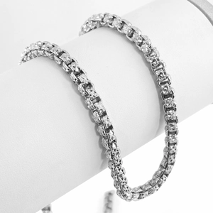 Macro shot of silver stainless steel box chain necklace with diamond-cut faceted details