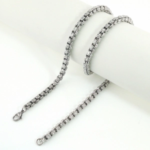 Macro view of stainless steel box chain with geometric texture and lobster clasp