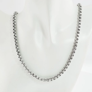 Detailed view of silver thick box chain necklace with textured geometric embossed links