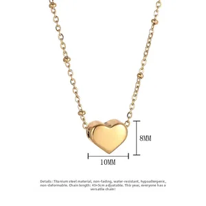 Detail of 18k gold heart pendant and beaded titanium steel chain with size markers
