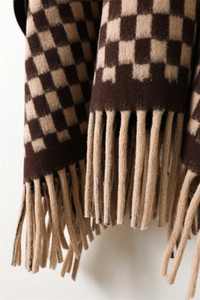Close-up of vintage brown checkerboard knit scarf featuring soft cashmere texture and long tassels