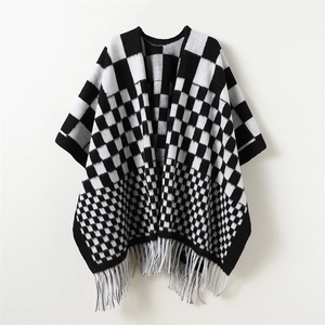 Classic black and white checkered knit shawl poncho with fringe hem for winter warmth