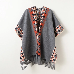 Ethnic knit shawl cloak in grey with geometric orange patterns and warm fringe hem