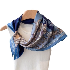 Blue and white paisley silk scarf with vintage floral patterns on a white hanger