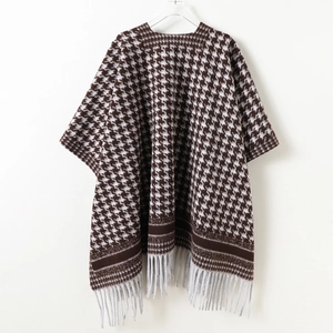 Classic houndstooth knit poncho cape with fringe tassels in brown and white winter style