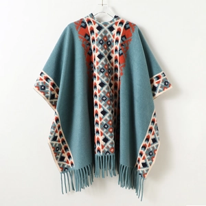 Ethnic knit poncho shawl with geometric patterns and fringe tassels in teal blue