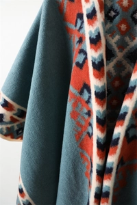 Close-up of thick brushed jacquard shawl with vibrant ethnic geometric patterns