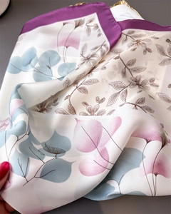 Detailed macro shot showing floral pattern on lightweight faux silk square scarf
