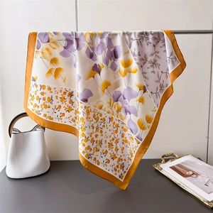 Elegant floral print silk-like square scarf with vibrant orange border and patchwork patterns