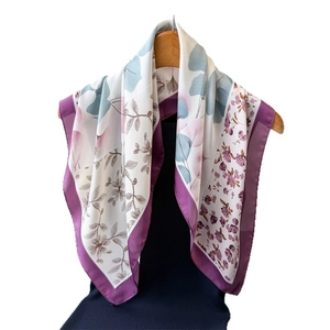 Floral faux silk square scarf in lilac and blue draped on a wooden hanger