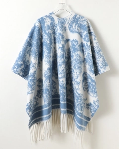 Close-up of blue and white ink wash patterned shawl with soft fringe detail