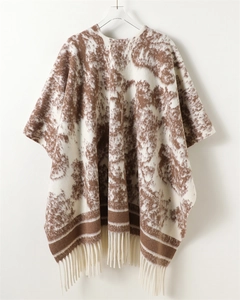 Detail of the knit texture with brown tie-dye ink patterns and decorative long tassels