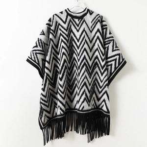 Black and white zigzag pattern knit shawl with tassels for winter warmth and style