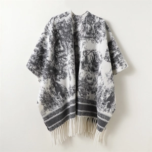 Women's reversible knit shawl cape with ink wash tree patterns and white fringe trim