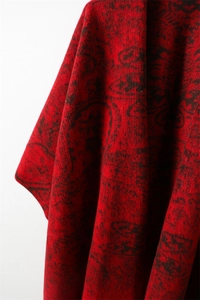 Close-up of deep red cashmere-feel shawl with black vintage bohemian paisley pattern