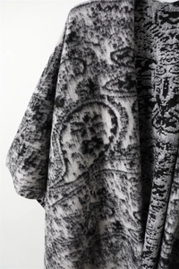 Close-up of black and white paisley jacquard fabric with soft brushed cashmere feel
