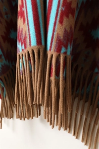 Close-up of geometric pattern cashmere-feel fabric and matching fringe tassels