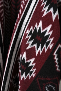 Close-up of geometric tribal pattern on thick cashmere-like shawl with wine red and black tones