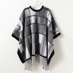Vintage black and white plaid knit poncho shawl with thick tassels and geometric pattern