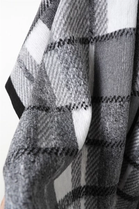 Close-up of vintage grey and white plaid scarf fabric with detailed knit texture