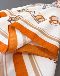 Detailed view of silk-like scarf with vintage floral prints and luxury patterns